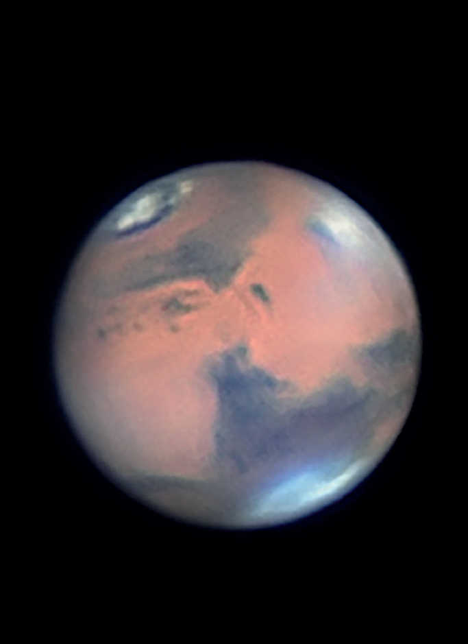 Picture of the planet Mars. The image clearly shows clouds in the region of the large shield volcano Elysium Mons. The largely melted northern polar cap is also very striking. Mario Weigand