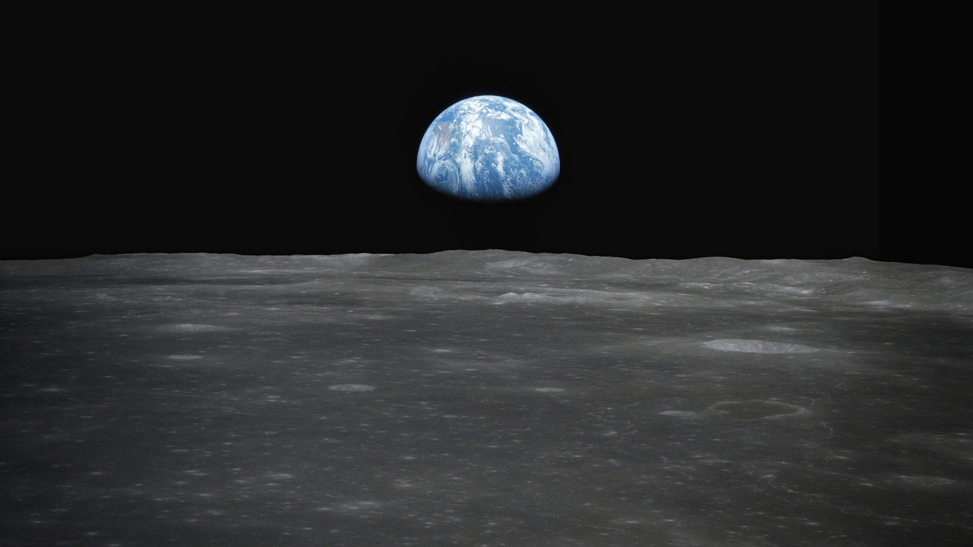 Earthrise above the surface of the Moon