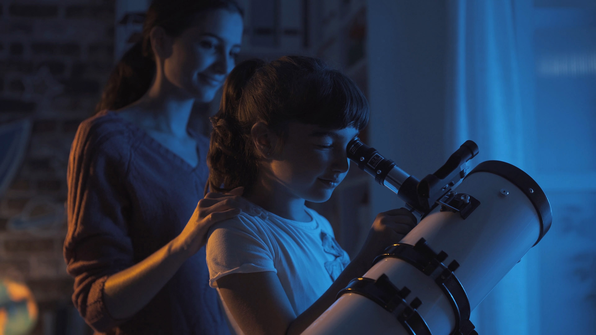 Moon, planets and stars close-up. With the right telescope, children and teenagers discover their passion for astronomy.  AstroStar/Shutterstock.com